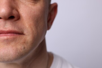 Obraz premium Clean shaven man on light background, closeup. Space for text