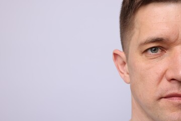 Fototapeta premium Handsome man on light background, closeup. Space for text