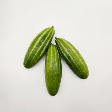 Potol or pointed gourd vegetable on isolated white background. Pointed gourds over white background. Green vegetable. High resolution image.