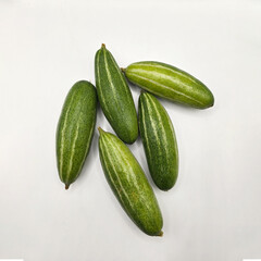 Potol or pointed gourd vegetable on isolated white background. Pointed gourds over white background. Green vegetable. High resolution image.