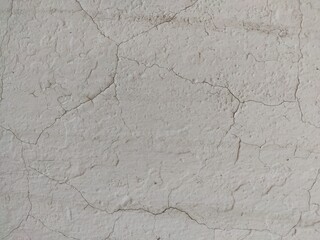 Aged white plaster wall with fine cracks great for architectural textures, retro-style designs, and aged wall surfaces