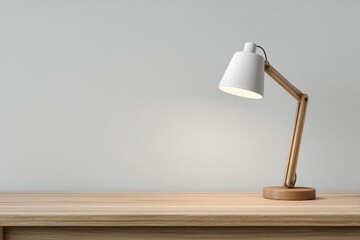 Elegant workspace arrangement with a white desk lamp illuminating a simple wooden desk adorned with negative space