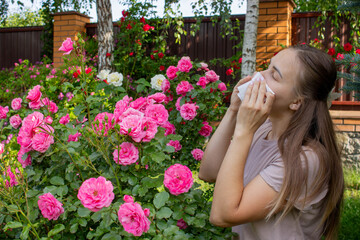 Allergy to flowers. Woman in the garden with a napkin allergy. Selective focus