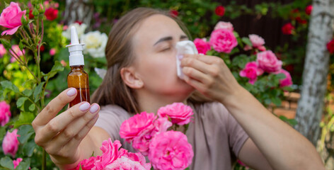 Allergy to flowers. Woman in the garden with a napkin allergy. Selective focus