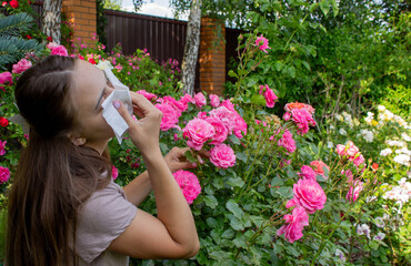 Allergy to flowers. Woman in the garden with a napkin allergy. Selective focus