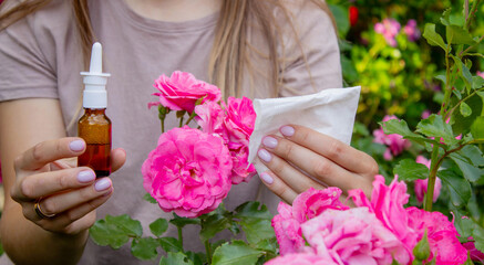 Allergy to flowers. Woman in the garden with a napkin allergy. Selective focus