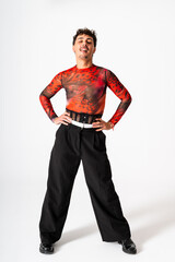 Young Gay Man Smiling Confidently in Urban-Inspired Fashion Against a Plain White Background