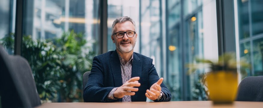 The businessman engaging in a professional conversation in a modern office setting.
