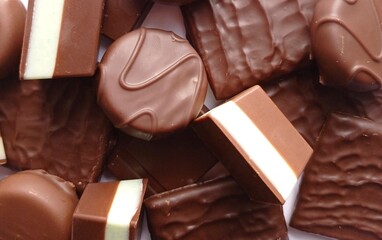 Close up of a pile of various chocolate candies.