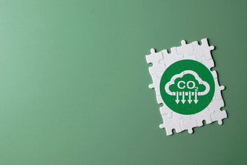 Concept for climate action,carbon emission reduction,net-zero,ESG,carbon footprint,Eco-friendl.,White puzzle with reduce co2 carbon icon on green background idea for business,industrial,enviromental.