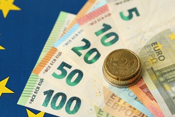 European union money currency Euro different paper notes and coins on flag