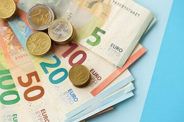 European union Euro money bills and coins on blue table