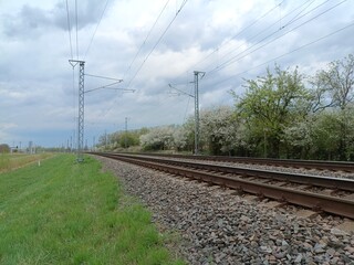 Two way railroad tracks in countryside. Two railway tracks. Cloudy day. Countryside. Fields and...