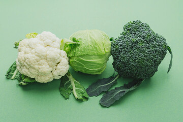 Broccoliб cabbage and cauliflower mix on green background healthy diet concept