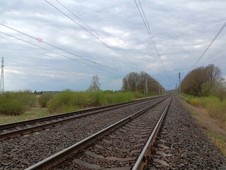 Two way railroad tracks in countryside. Two railway tracks. Cloudy day. Countryside. Fields and...