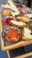 Italian food with red sauce from tomato and slice of bread as a appetizer or lunch in restaurant. Healthy vegetarian meal in a bowl with toast. Close up and vertical.