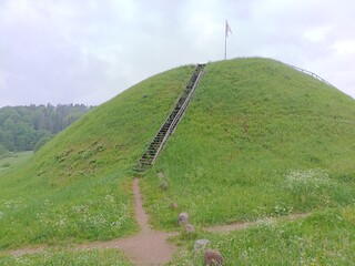 Bubiai hill during cloudy day. Small hill. Grass is growing on hill. Staircase leading to the top....