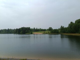 Bubiai lake during cloud day. Lake with small waves. Cloudy day with white and gray clouds in sky. Nature. Bubiu ezeras.