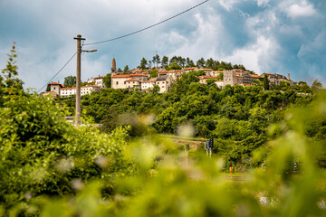 Scenic Hilltop Town Of Stanjel In Slovenia: Traditional Stone Houses And Historic Church Tower...
