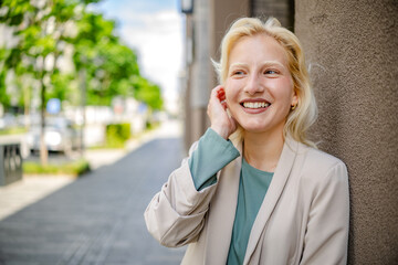 Young woman with albinism smiles while enjoying a sunny day in the city, showcasing her radiant...