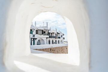 Iconic White Architecture Of Binibeca Vell Village Seen Through An Archway. Menorcan Coastal Town, Whitewashed Houses, Balearic Islands Travel
