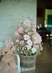 Artificial flowers in jars on the tables