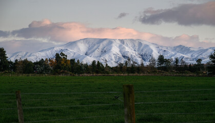 Fototapeta premium Snow-capped mountains at sunrise. Winter landscape of Canterbury. South Island. New Zealand.