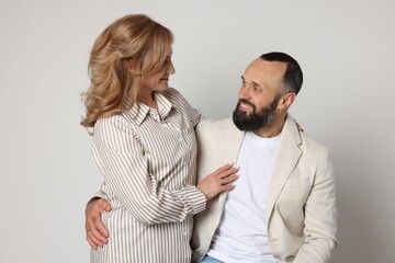 Portrait of lovely couple on light grey background