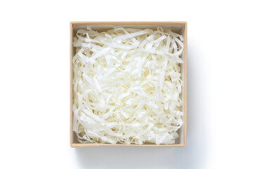 Brown gift box with shredded paper on white background. Top view