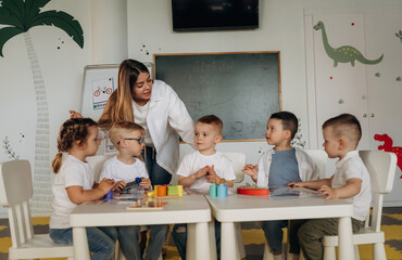 Colorful toys, educational game. Children in kindergarten with their teacher