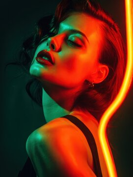 Stylish portrait of a woman in red and green neon light. Sensual, glamorous, and modern. Perfect for fashion, beauty, and nightlife projects.