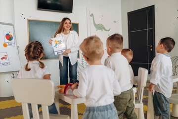 Socialization and education. Children in kindergarten with their teacher