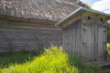 A small wooden building with a roof and a door