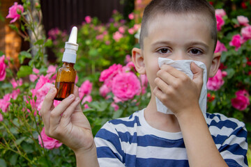 Child Sneezing from Flower Allergy. Selective focus