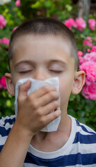 Child Sneezing from Flower Allergy. Selective focus