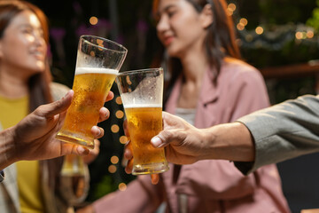 food and drink male friends are happy drinking beer and clinking glasses at a bar or pub.