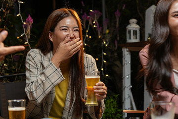  
food and drink male friends are happy drinking beer and clinking glasses at a bar or pub.