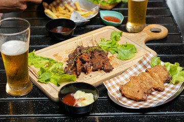 food and drink male friends are happy drinking beer and clinking glasses at a bar or pub.