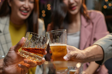 food and drink male friends are happy drinking beer and clinking glasses at a bar or pub.