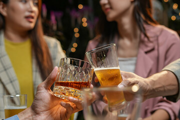 food and drink male friends are happy drinking beer and clinking glasses at a bar or pub.