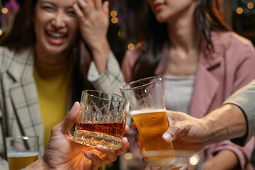 food and drink male friends are happy drinking beer and clinking glasses at a bar or pub.