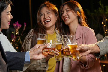 food and drink male friends are happy drinking beer and clinking glasses at a bar or pub.