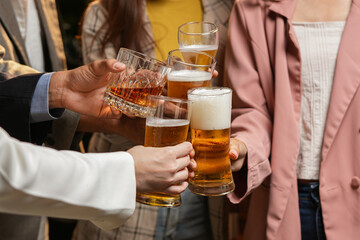 food and drink male friends are happy drinking beer and clinking glasses at a bar or pub.