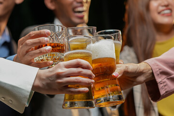 food and drink male friends are happy drinking beer and clinking glasses at a bar or pub.