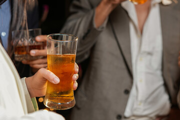 food and drink male friends are happy drinking beer and clinking glasses at a bar or pub.