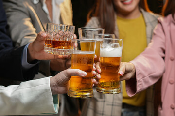 food and drink male friends are happy drinking beer and clinking glasses at a bar or pub.