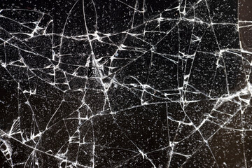 broken with a lot of pieces of glass on a black background, thin glass broken into pieces, close up