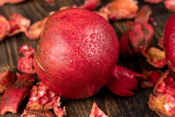 a wet pomegranate close up, a sweet red pomegranate in drops of clear water