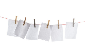Clothesline with blank sheets of paper hung up with wooden clothespins isolated on a white background, mock up, copy space