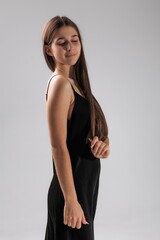 Model poses gracefully in a minimalist studio setting highlighting natural beauty and elegance in...